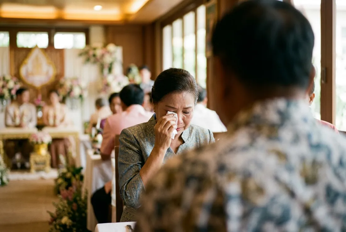 ญาติผู้ใหญ่ซับน้ำตาระหว่างพิธี